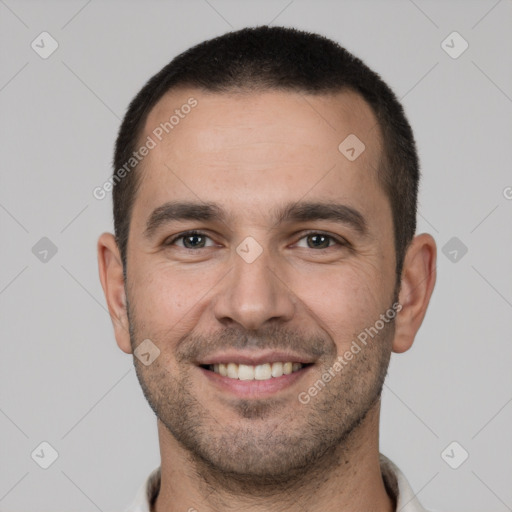 Joyful white young-adult male with short  brown hair and brown eyes