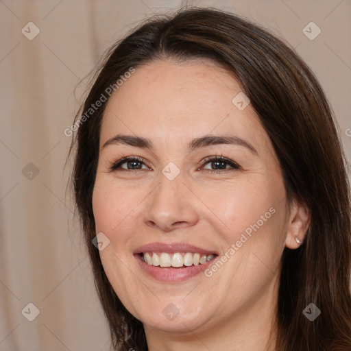 Joyful white adult female with medium  brown hair and brown eyes