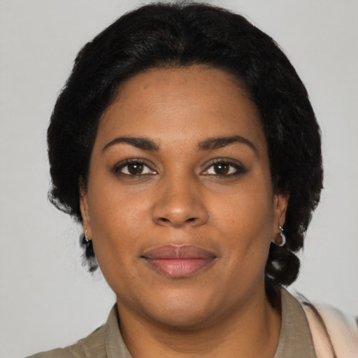 Joyful black young-adult female with medium  black hair and brown eyes