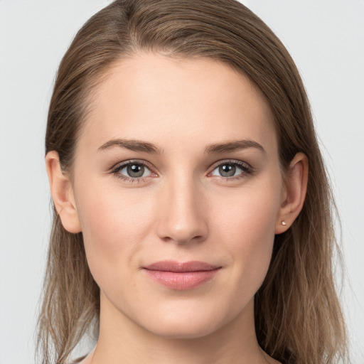 Joyful white young-adult female with long  brown hair and grey eyes