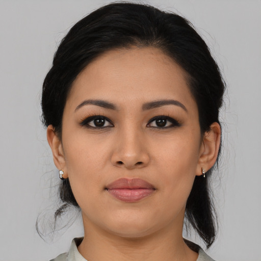 Joyful latino young-adult female with medium  black hair and brown eyes