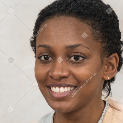 Joyful black young-adult female with short  brown hair and brown eyes