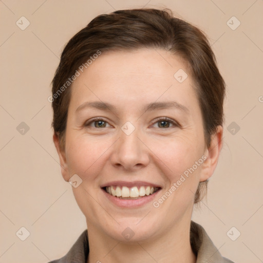 Joyful white young-adult female with short  brown hair and grey eyes