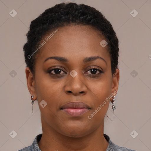 Joyful black young-adult female with short  brown hair and brown eyes