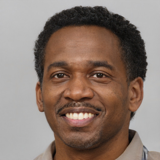 Joyful latino adult male with short  brown hair and brown eyes