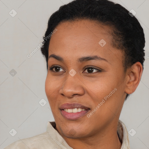 Joyful black young-adult female with short  black hair and brown eyes