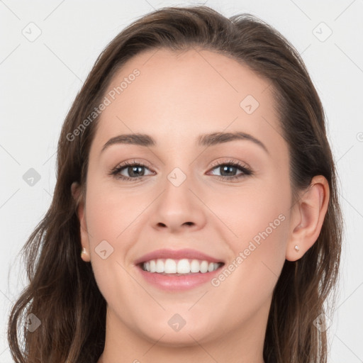 Joyful white young-adult female with long  brown hair and grey eyes