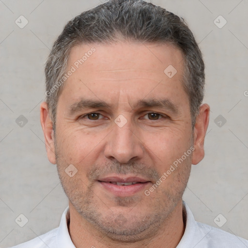 Joyful white adult male with short  brown hair and brown eyes