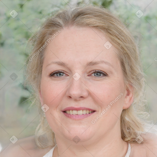 Joyful white adult female with medium  brown hair and blue eyes