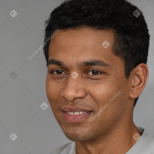 Joyful black young-adult male with short  black hair and brown eyes