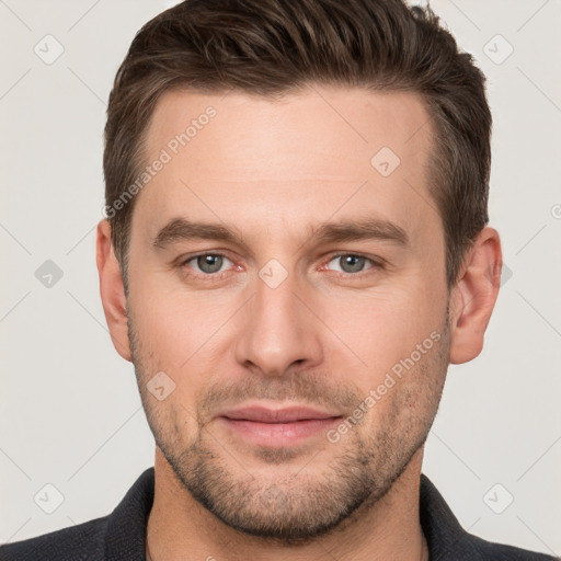 Joyful white young-adult male with short  brown hair and grey eyes