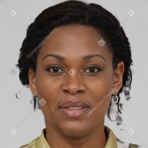 Joyful black adult female with medium  brown hair and brown eyes