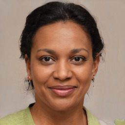 Joyful black adult female with medium  brown hair and brown eyes