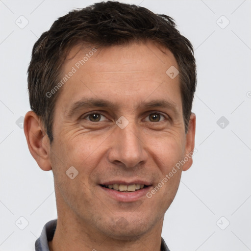 Joyful white adult male with short  brown hair and brown eyes