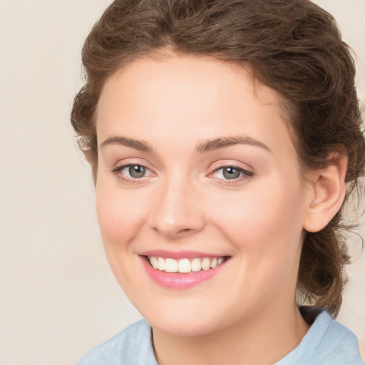 Joyful white young-adult female with medium  brown hair and green eyes