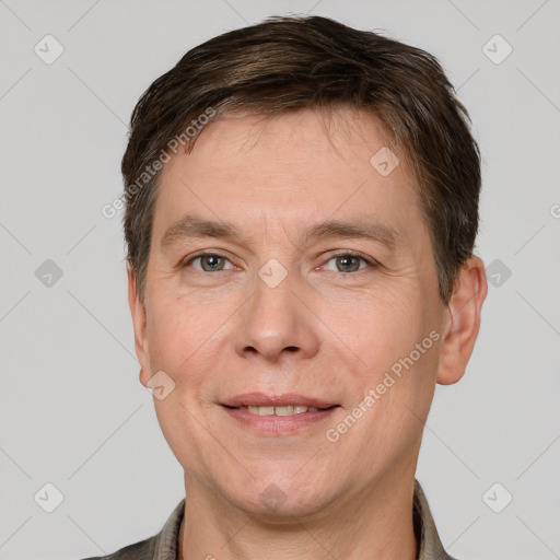 Joyful white adult male with short  brown hair and grey eyes