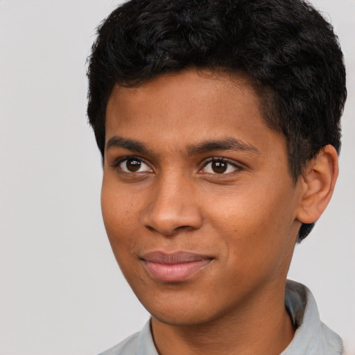 Joyful black young-adult male with short  black hair and brown eyes