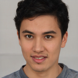 Joyful latino young-adult male with short  brown hair and brown eyes