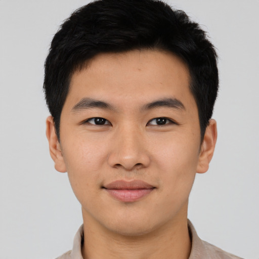 Joyful asian young-adult male with short  black hair and brown eyes