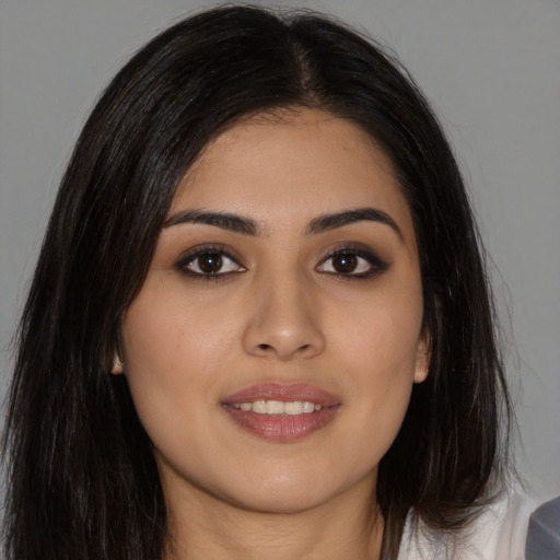 Joyful asian young-adult female with long  brown hair and brown eyes