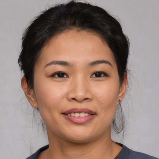 Joyful asian young-adult female with medium  brown hair and brown eyes