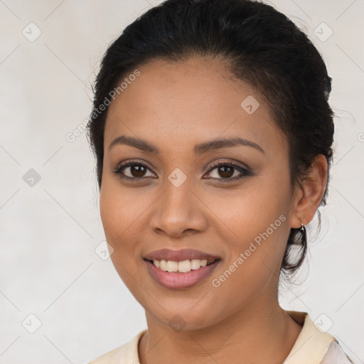 Joyful latino young-adult female with long  brown hair and brown eyes