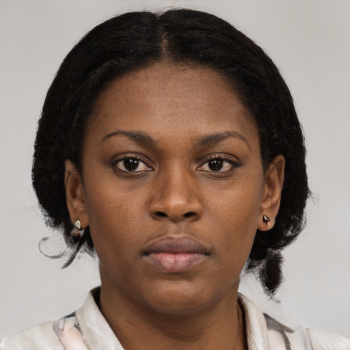 Neutral black young-adult female with medium  brown hair and brown eyes