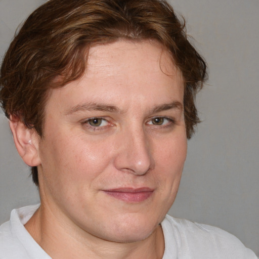 Joyful white young-adult male with short  brown hair and blue eyes