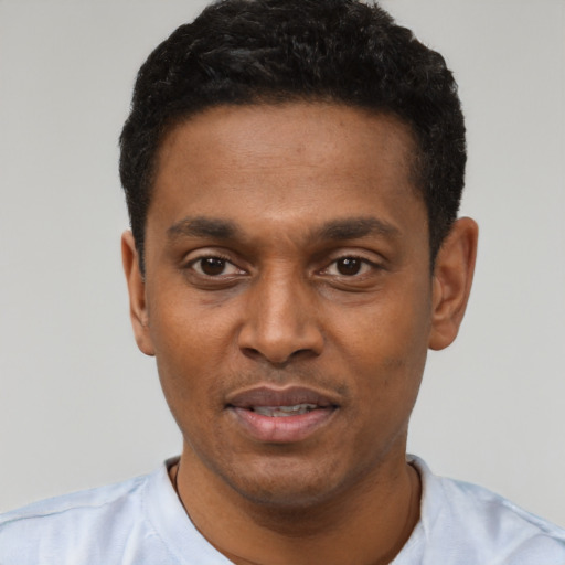 Joyful latino young-adult male with short  black hair and brown eyes