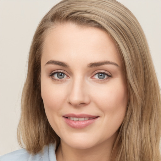 Joyful white young-adult female with long  brown hair and green eyes