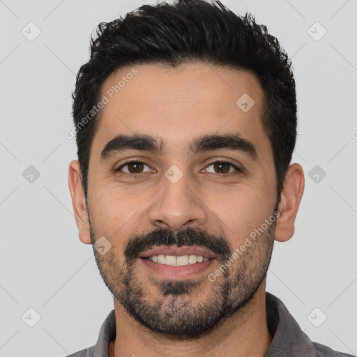 Joyful latino young-adult male with short  black hair and brown eyes