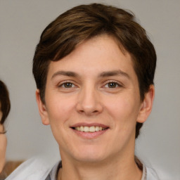 Joyful white young-adult female with short  brown hair and grey eyes