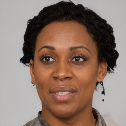 Joyful black adult female with short  black hair and brown eyes
