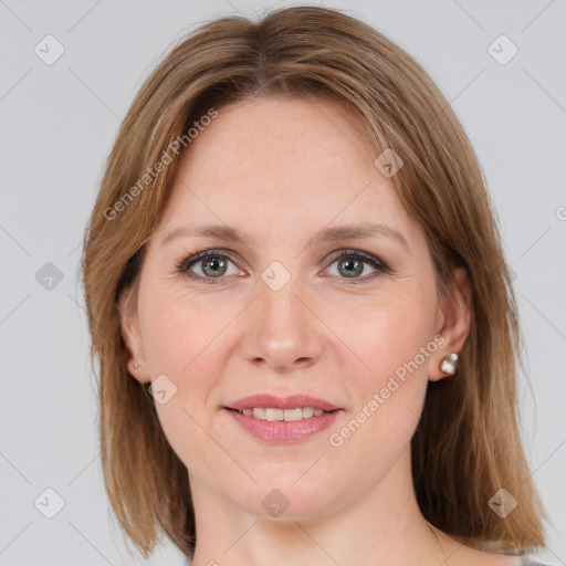 Joyful white adult female with medium  brown hair and grey eyes