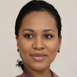 Joyful black young-adult female with short  black hair and brown eyes
