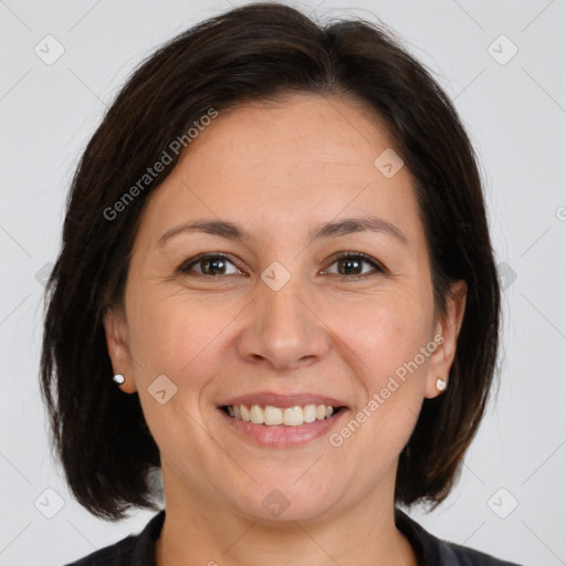 Joyful white adult female with medium  brown hair and brown eyes