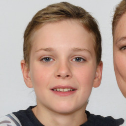 Joyful white child female with medium  brown hair and blue eyes