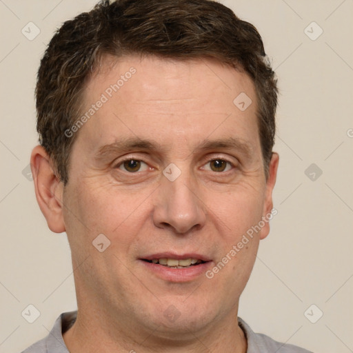 Joyful white adult male with short  brown hair and grey eyes