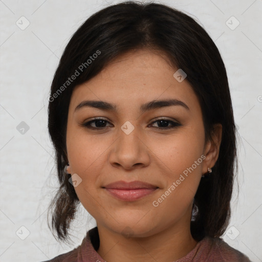 Joyful latino young-adult female with medium  brown hair and brown eyes