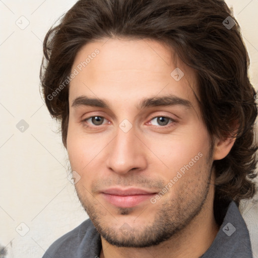 Joyful white young-adult male with medium  brown hair and brown eyes