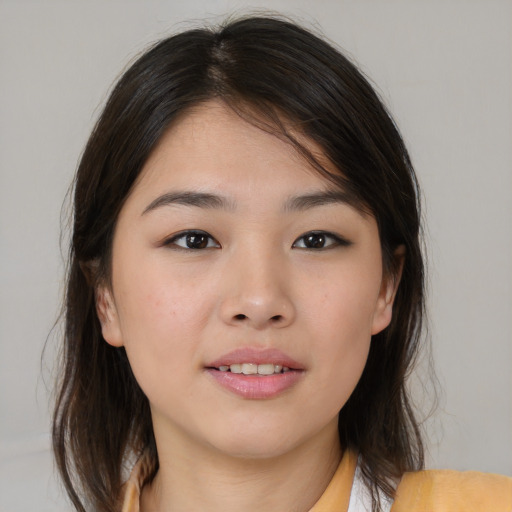 Joyful asian young-adult female with medium  brown hair and brown eyes