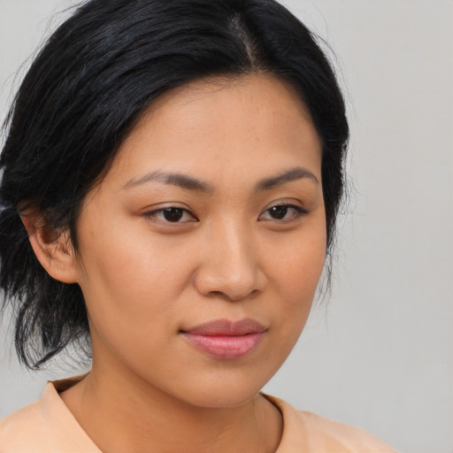 Joyful asian young-adult female with medium  brown hair and brown eyes