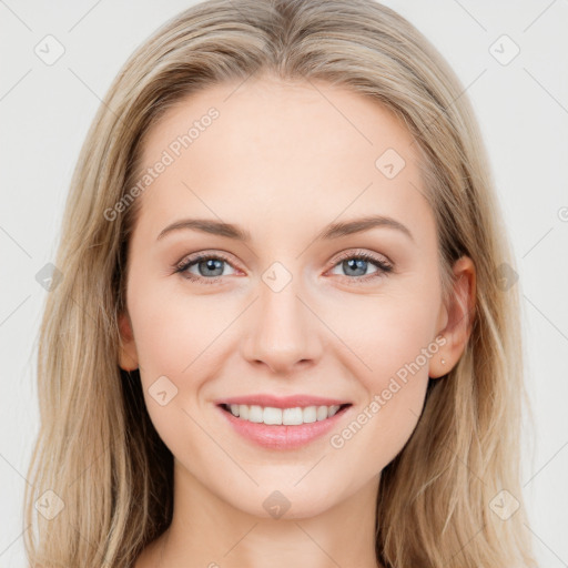 Joyful white young-adult female with long  brown hair and blue eyes