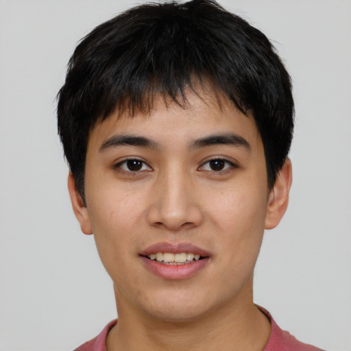 Joyful asian young-adult male with short  brown hair and brown eyes