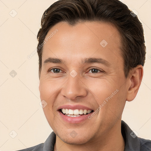 Joyful white young-adult male with short  brown hair and brown eyes