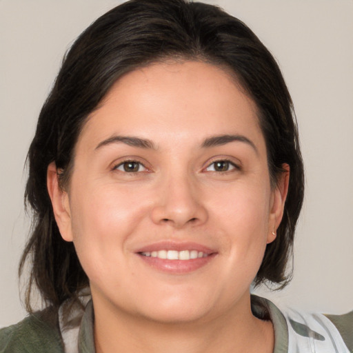 Joyful white young-adult female with medium  brown hair and brown eyes