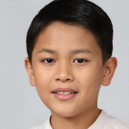 Joyful asian child male with short  brown hair and brown eyes