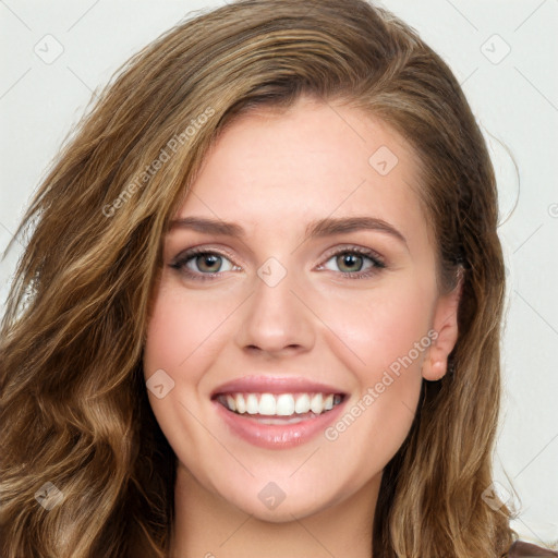 Joyful white young-adult female with long  brown hair and green eyes