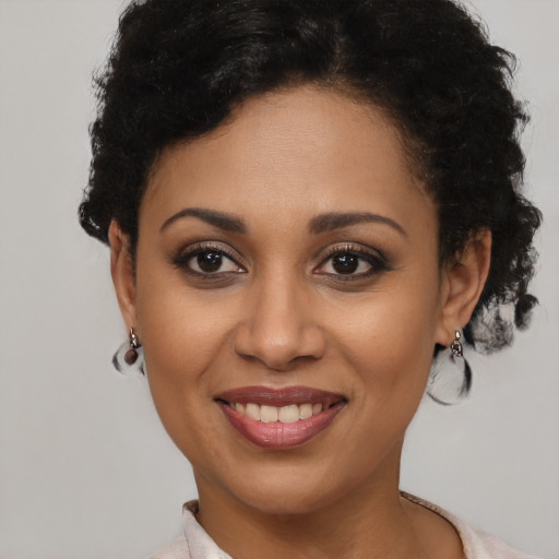 Joyful latino young-adult female with short  brown hair and brown eyes