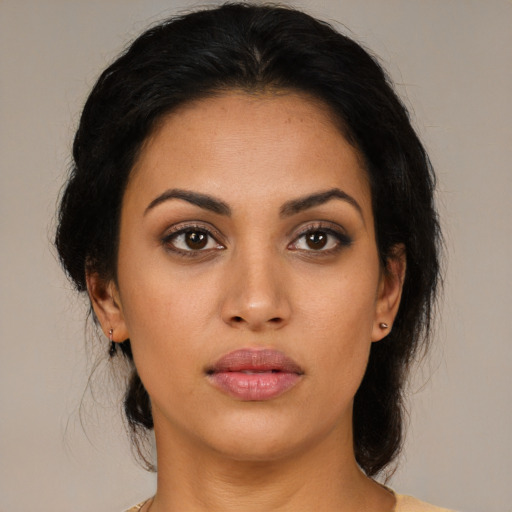 Joyful latino young-adult female with medium  brown hair and brown eyes